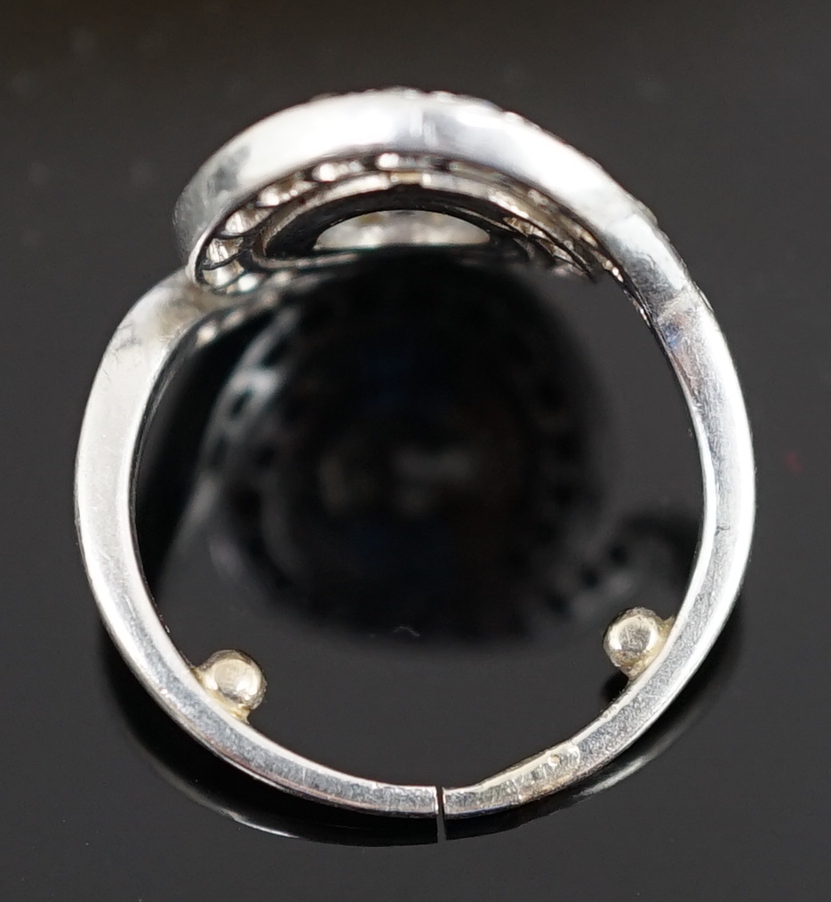 A mid 20th century platinum and diamond cluster set ring, of spiralling design